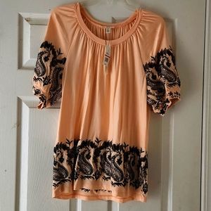 Peach top with cap sleeves. Black embroidery